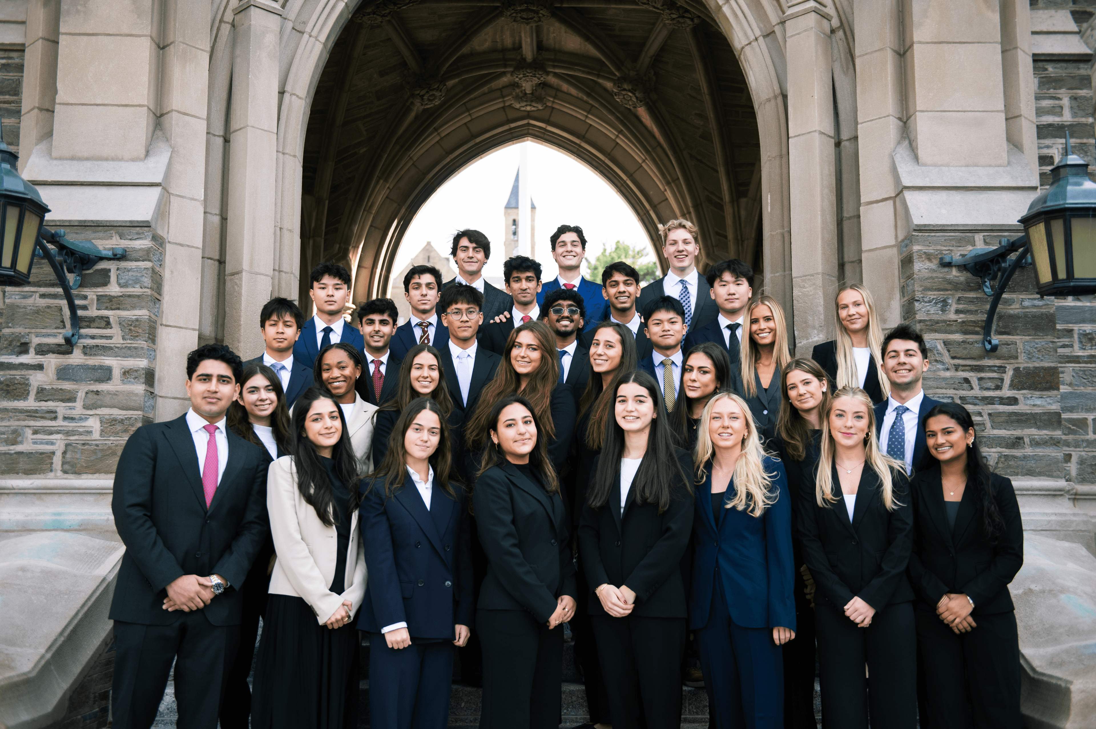 CPEC members outside an iconic Cornell archway